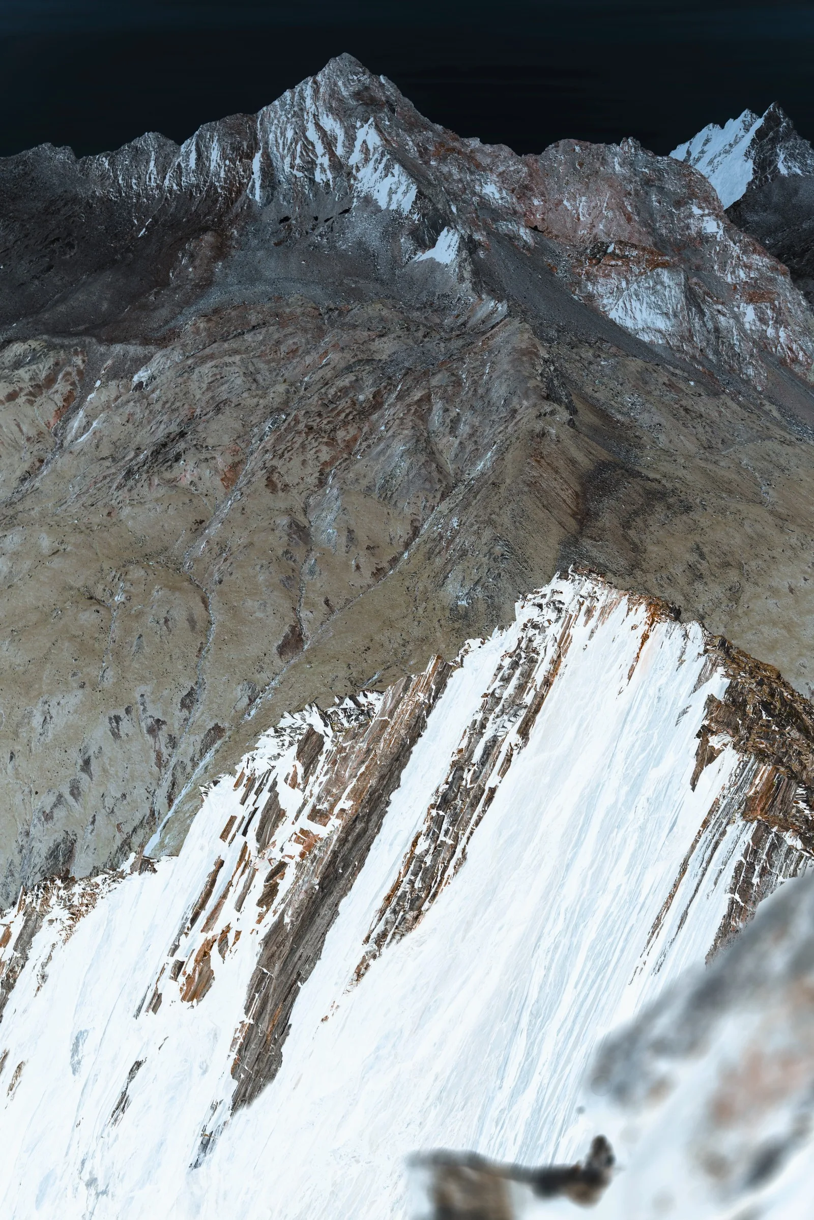 A rocky mountain ridge in inverted, light tones